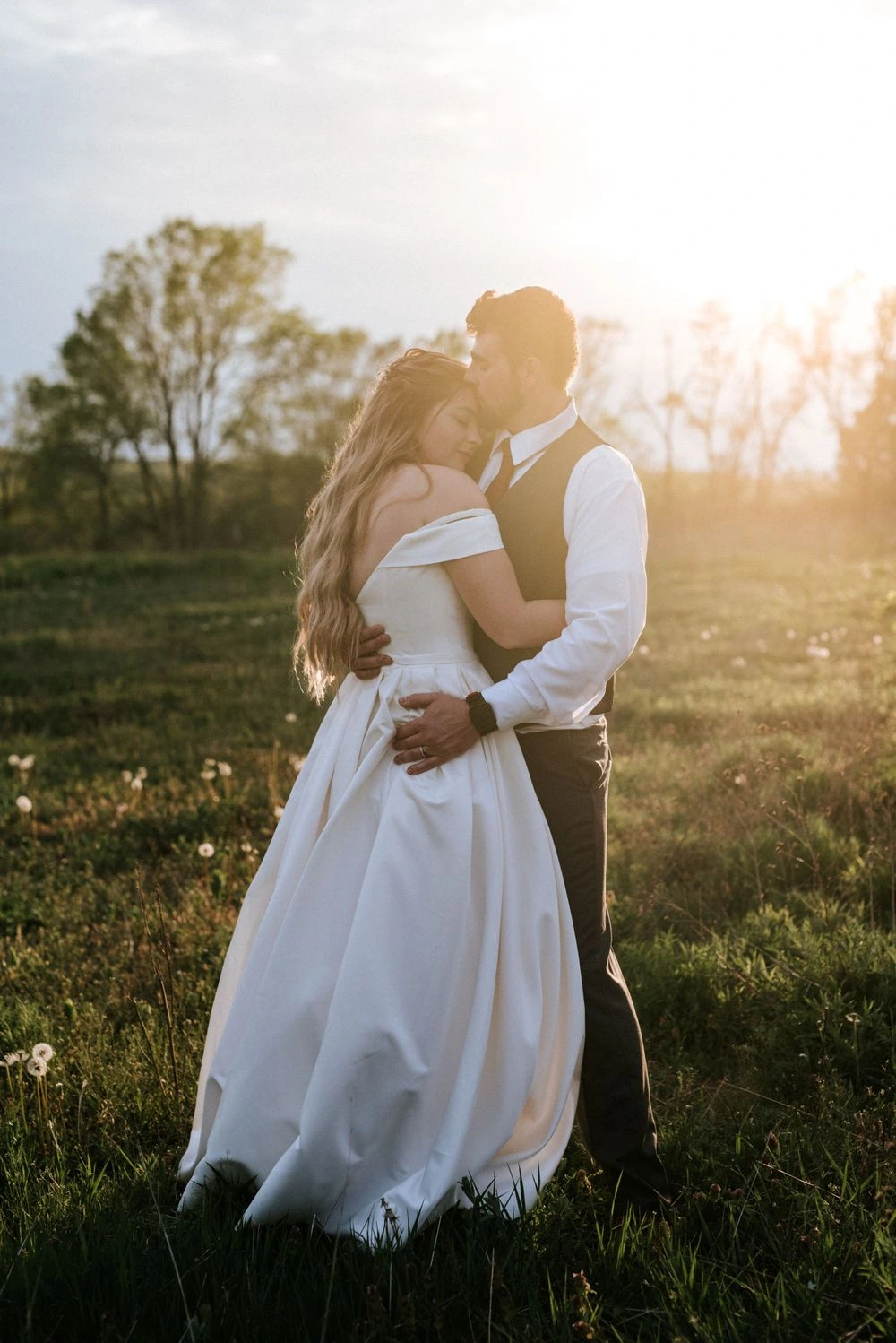 A couple embracing together in warm golden light