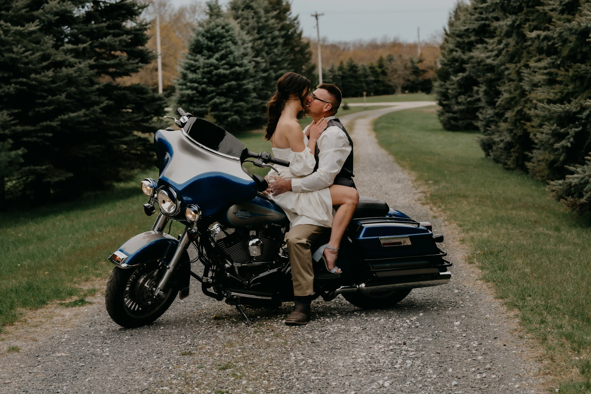 Newlyweds sharing a playful moment on a motorcycle